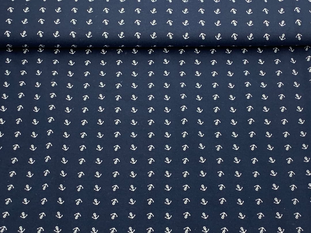 Desk with leather desk pad, walnut desk organizer, wireless keyboard and mouse, and porcelain mug.